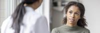 Young woman listens to doctor during office examination.